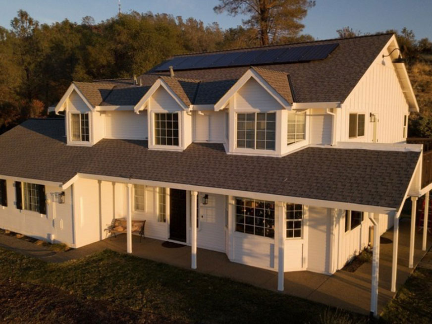 White home with detailed trim and covered porch, photographed for the existing Resurrection Painting website